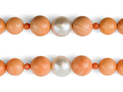 Fig.1: White freshwater cultured pearl surrounded by two beads cut in a gastropod shell on both sides and smaller coral beads.
