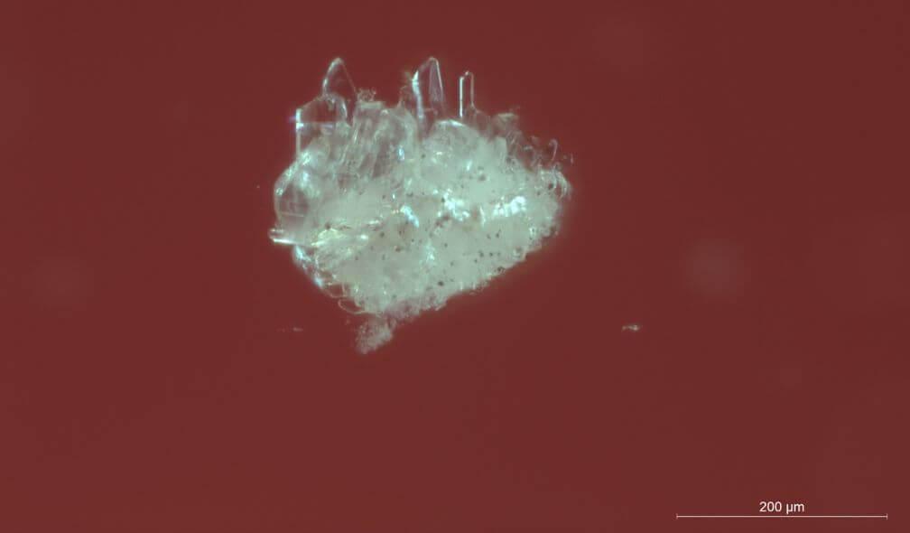 Automorphous phenacite crystals in a synthetic emerald