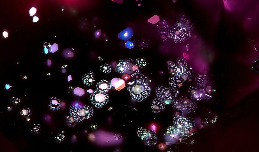 Natural glass inclusions in the form of atolls in an unheated ruby