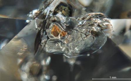 inclusion of an orange pyrope almandine garnet crystal in a diamond